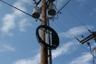 Splice enclosure on power pole